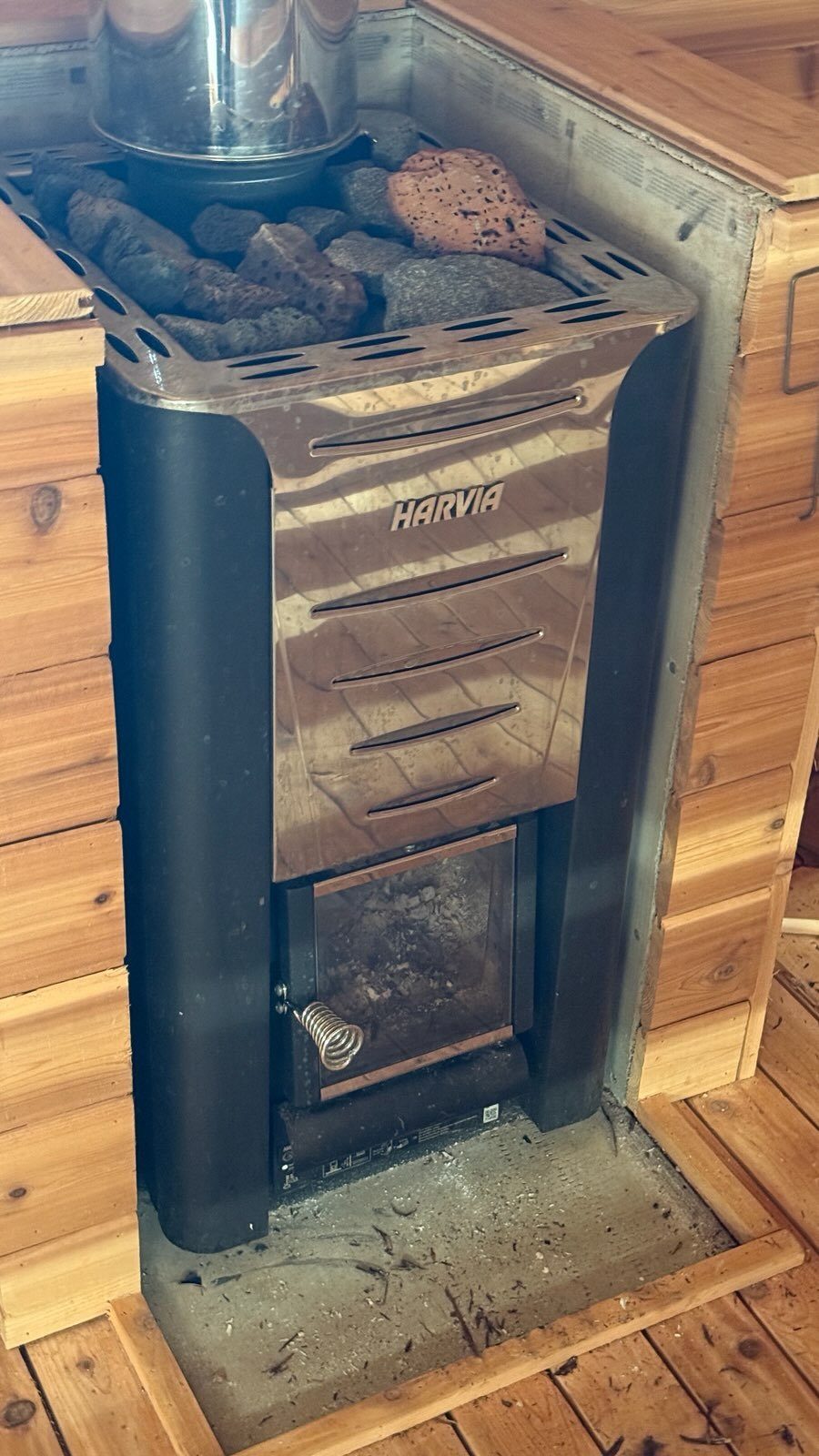 The Harvia wood stove at the center of the sauna