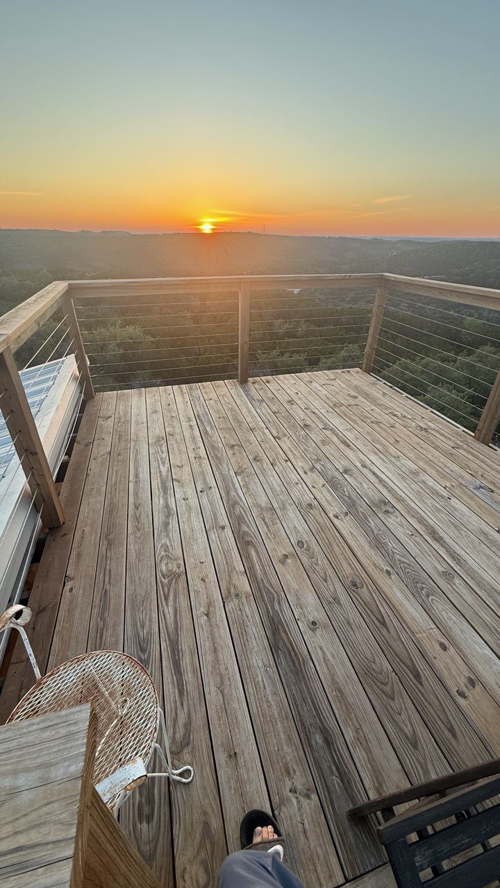 The sun touching the horizon from the west-facing deck