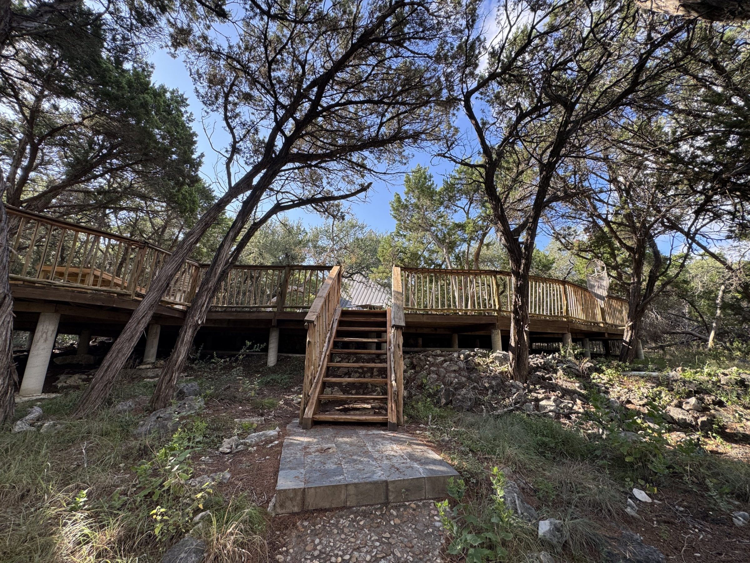 The wooded boardwalk connecting the glamping cabins