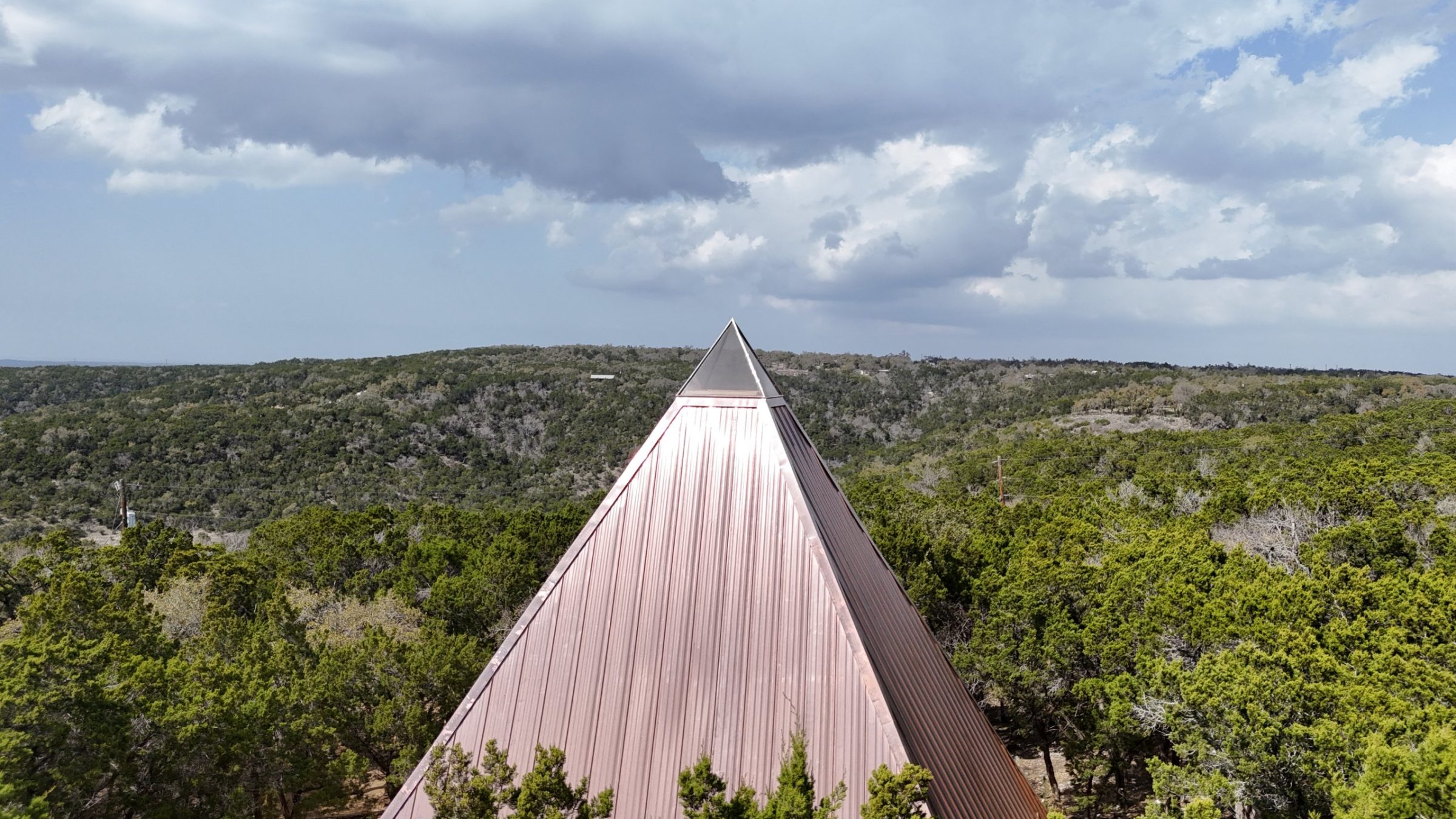 The 40-foot ceremony pyramid rising above the Hill Country tree line