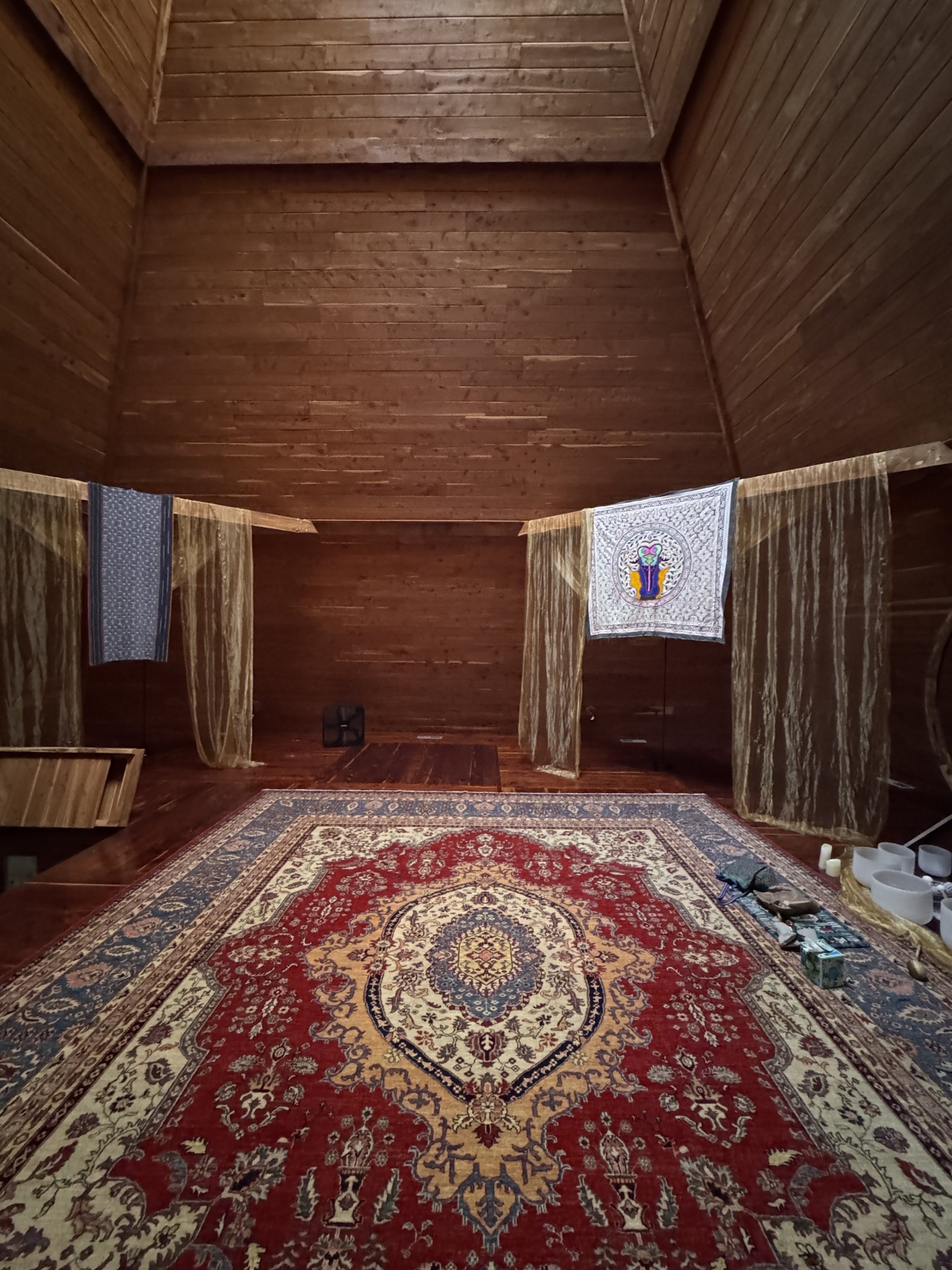 The cedar-lined pyramid interior dressed with rugs