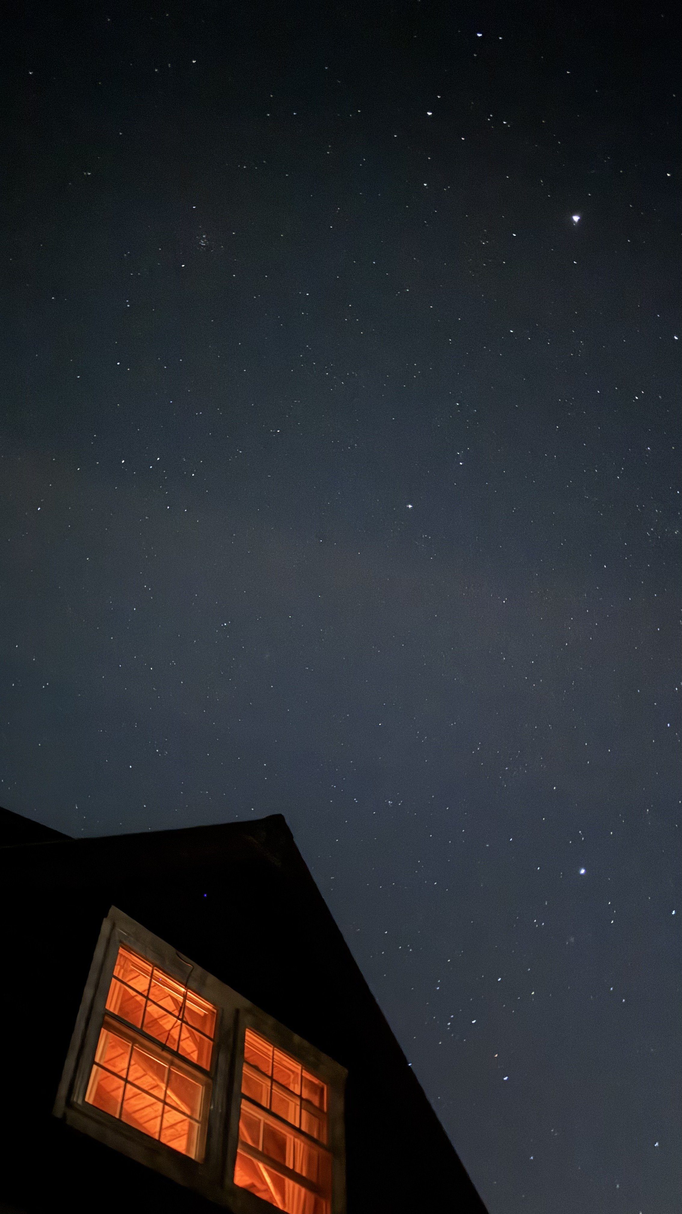 Stars thick overhead as the lodge windows glow below