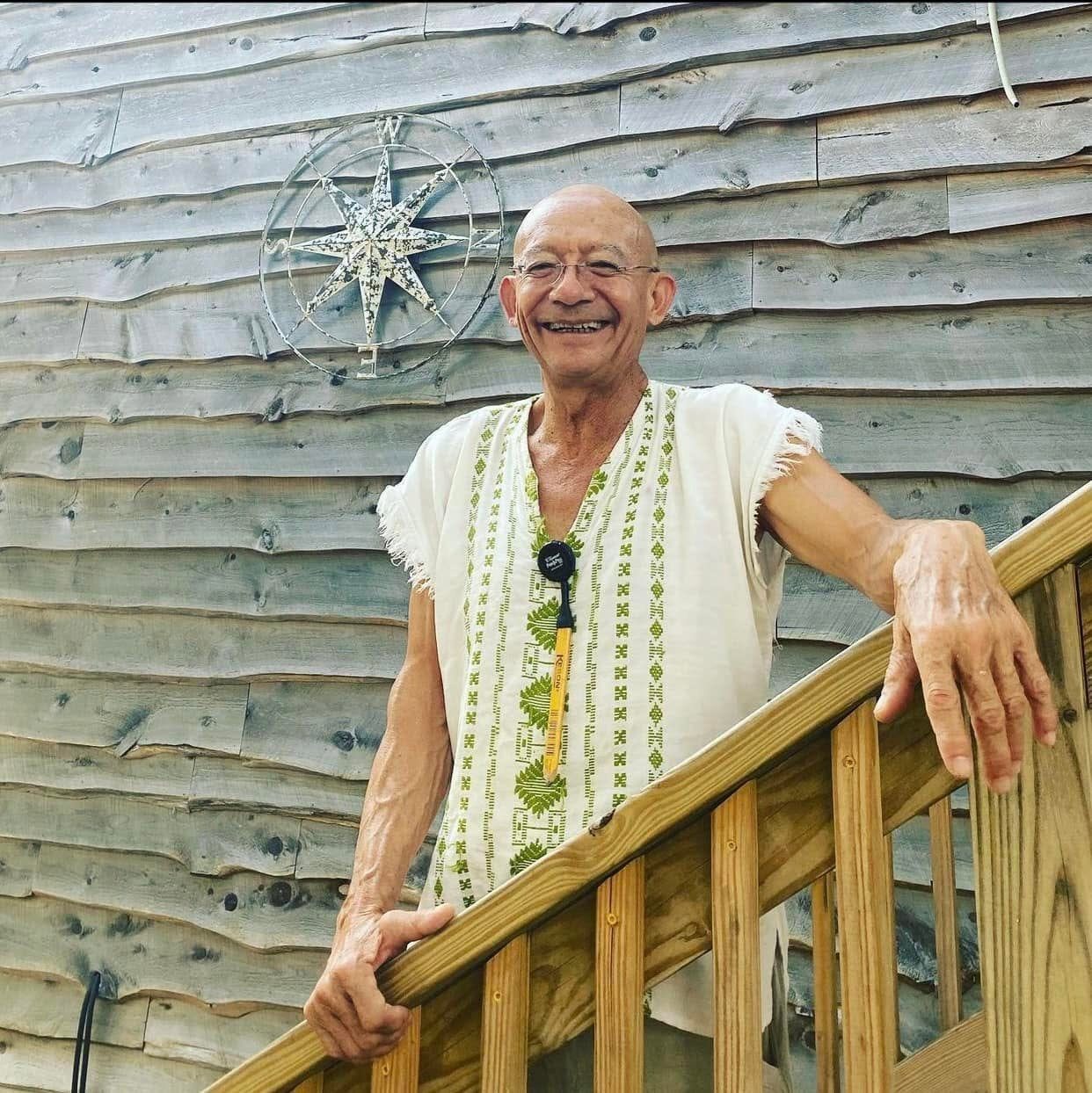Ricardo Gonzalez-Jurado on the cedar-shake stairway he built, beside a compass rose set into the shingles