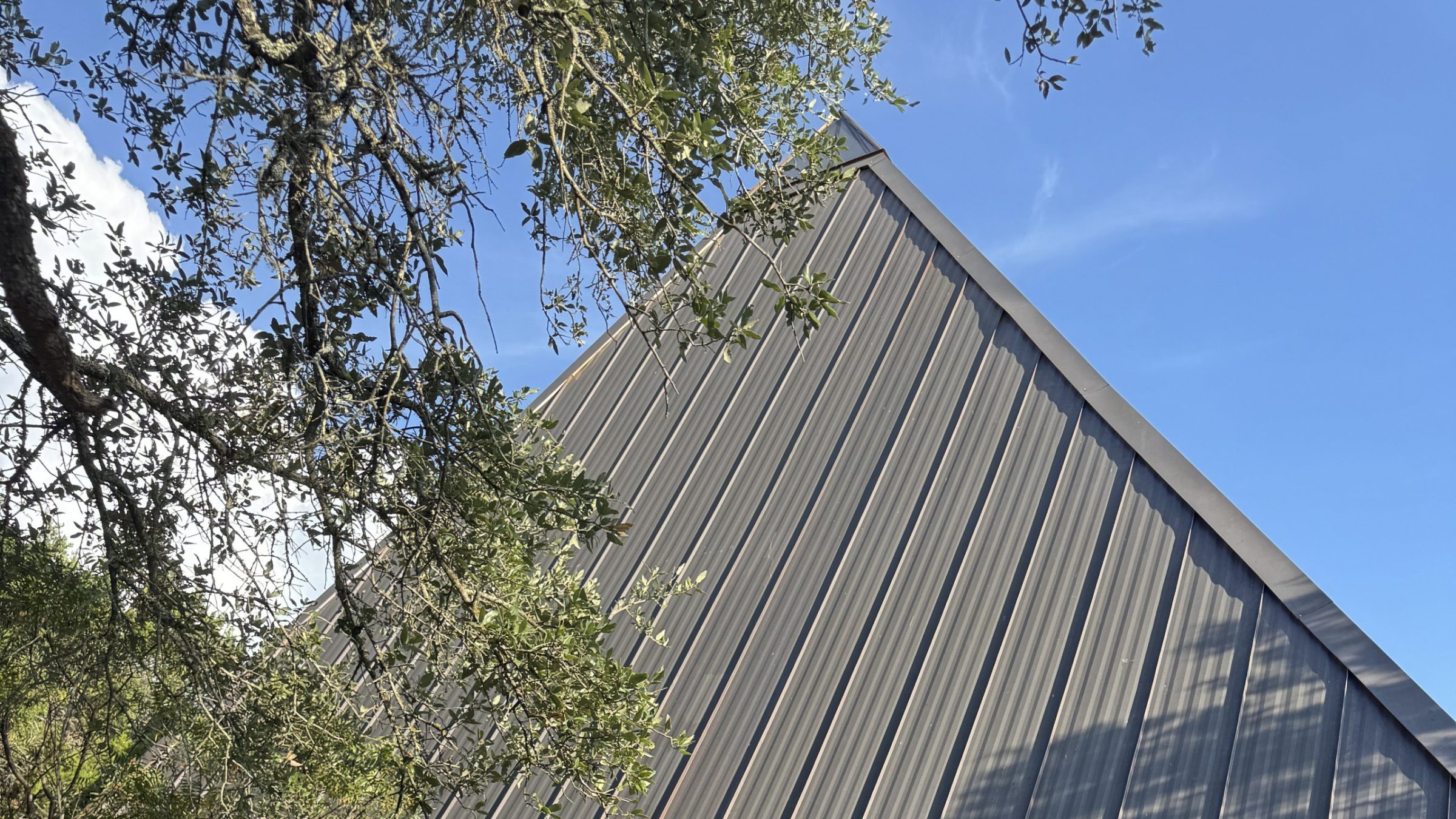 The pyramid's steel-clad face rising over the entrance porch