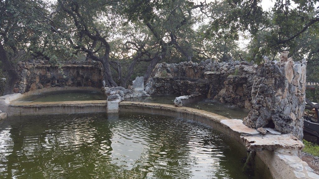 Tiered stonework and the grotto wall around the pool