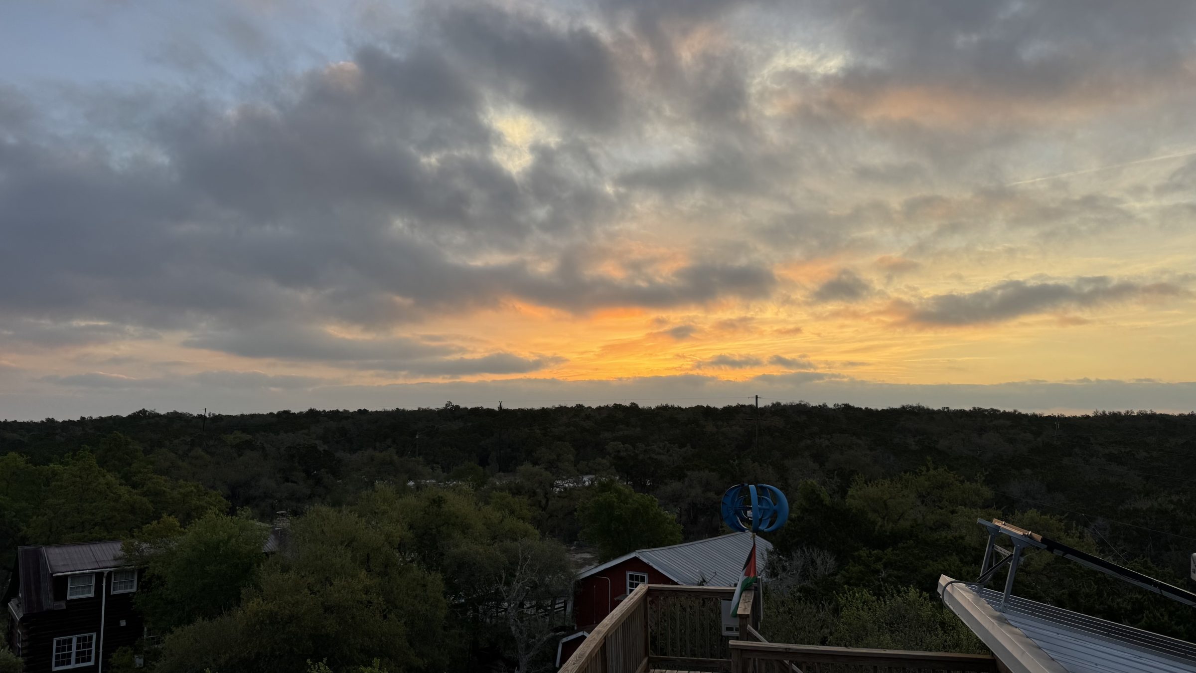 Sunset over the Hill Country tree canopy from the Heavenly View rooftop deck